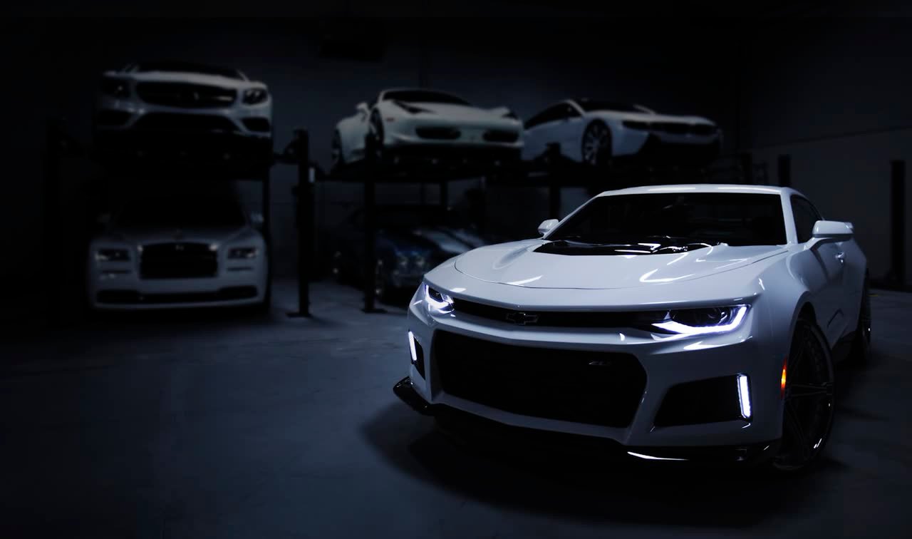 Vehicle presented in a darkened showroom