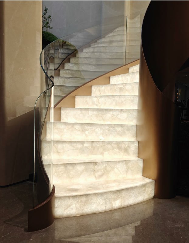 An illuminated stone staircase in a finished interior
